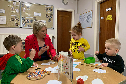Lisa Smart sat with young nursery children