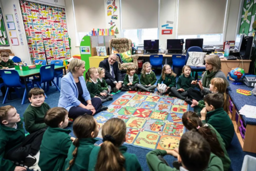 Lisa Smart and Sir Ed Davey with school children in a classroom. Copyright: Kenny Brown | Manchester Evening News